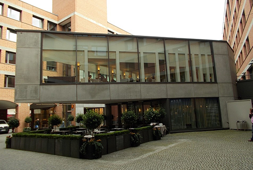 A building found in the centre of Munich which is interesting because it is hanging free in the air  with only one corner fixed to the ground.